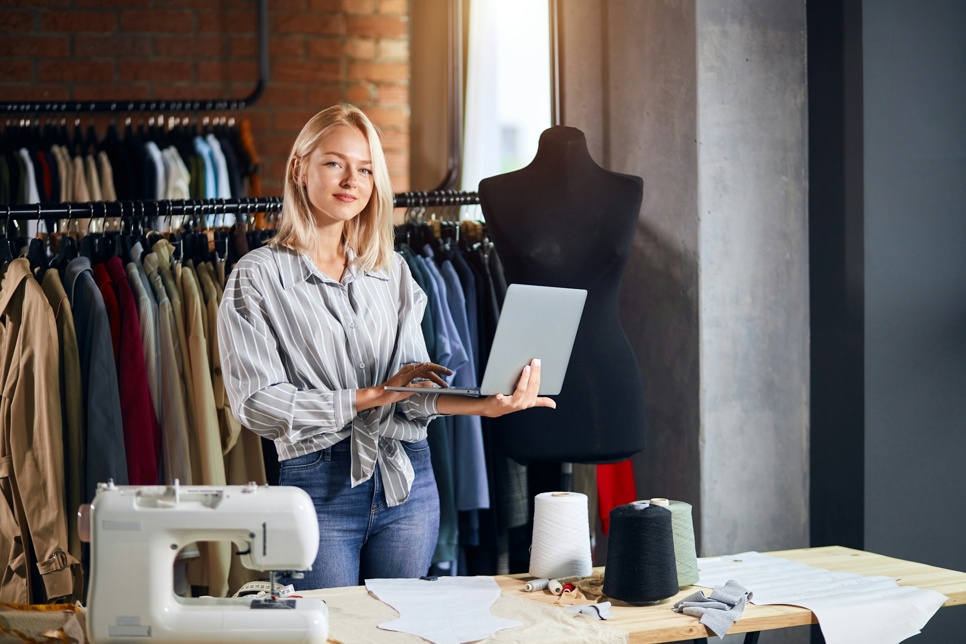 a woman holding a laptop to do her marketing