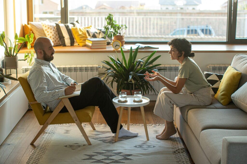 Two people discussing what is GEO a man and woman sitting on a couch discussing what is GEO