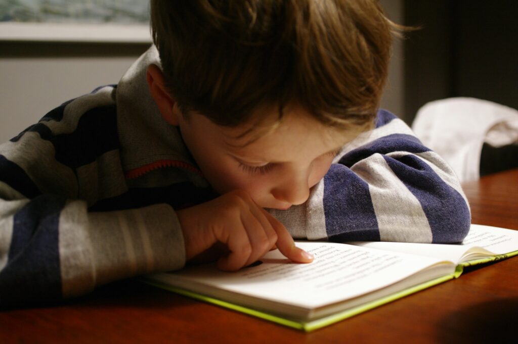 To know what is GEO, make content easy to read a boy lying on a table reading a book about what is GEO